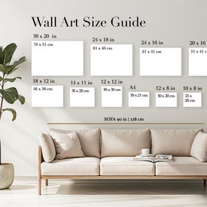May include: Wall art size guide with dimensions in inches and centimeters. Includes sizes such as 30 x 20 in (76 x 51 cm), 24 x 18 in (61 x 46 cm), and smaller options. A sofa, a plant, and a book are also visible.
