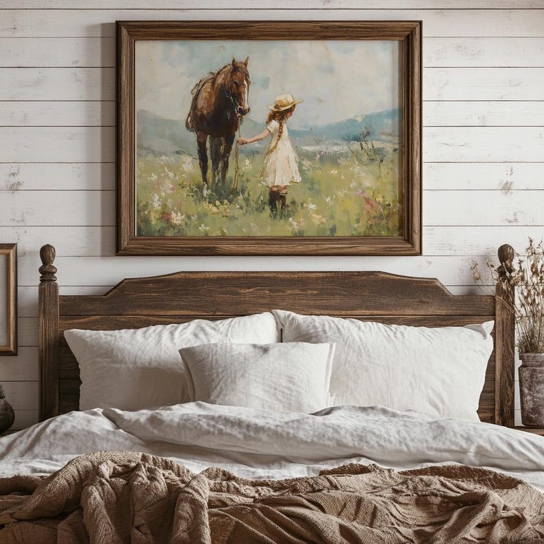 May include: A framed painting of a young girl in a white dress and a straw hat, holding the reins of a brown horse in a field of wildflowers.