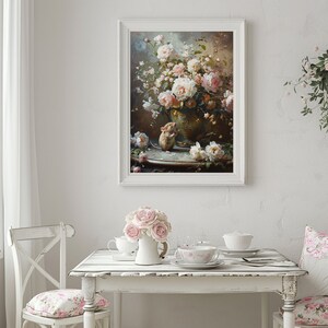 May include: A framed painting of a vase filled with pink roses and a small mouse sitting on a table. The vase is decorated with gold accents and the table is covered in a white tablecloth.