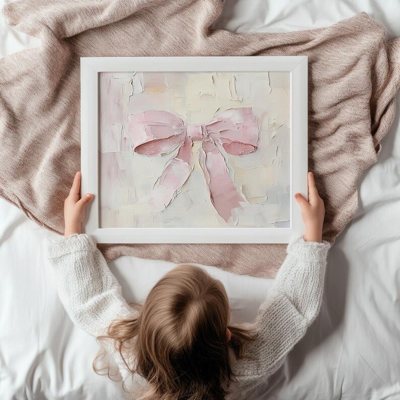 May include: A white frame with a pink bow painted on a canvas. The bow is painted in a textured style with a light background.