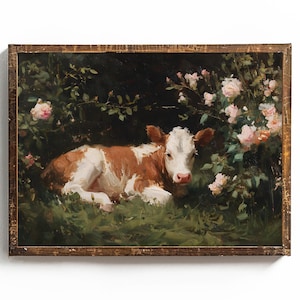 May include: A framed painting of a brown and white calf resting in a grassy area surrounded by pink roses and green foliage. The artwork has a rustic, vintage aesthetic with a dark background and a wooden frame.