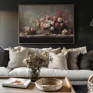 May include: A framed painting of a still life featuring a bouquet of pink and white roses in a vase, with a bowl of eggs on a table in front of the flowers.