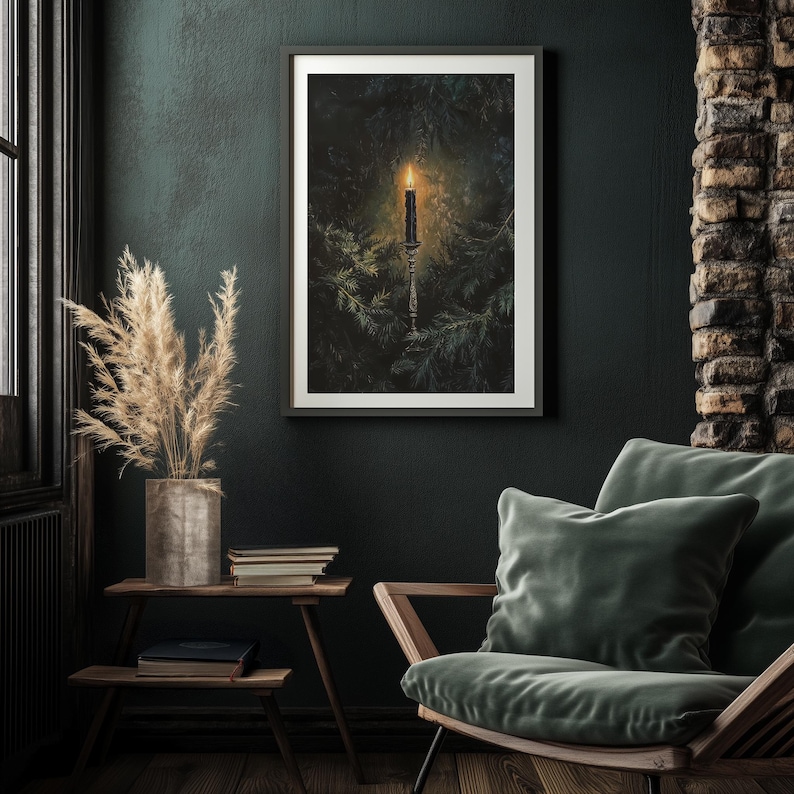 May include: A framed print of a candle burning in a dark forest setting. The candle is on a tall, ornate candlestick and is surrounded by green foliage.