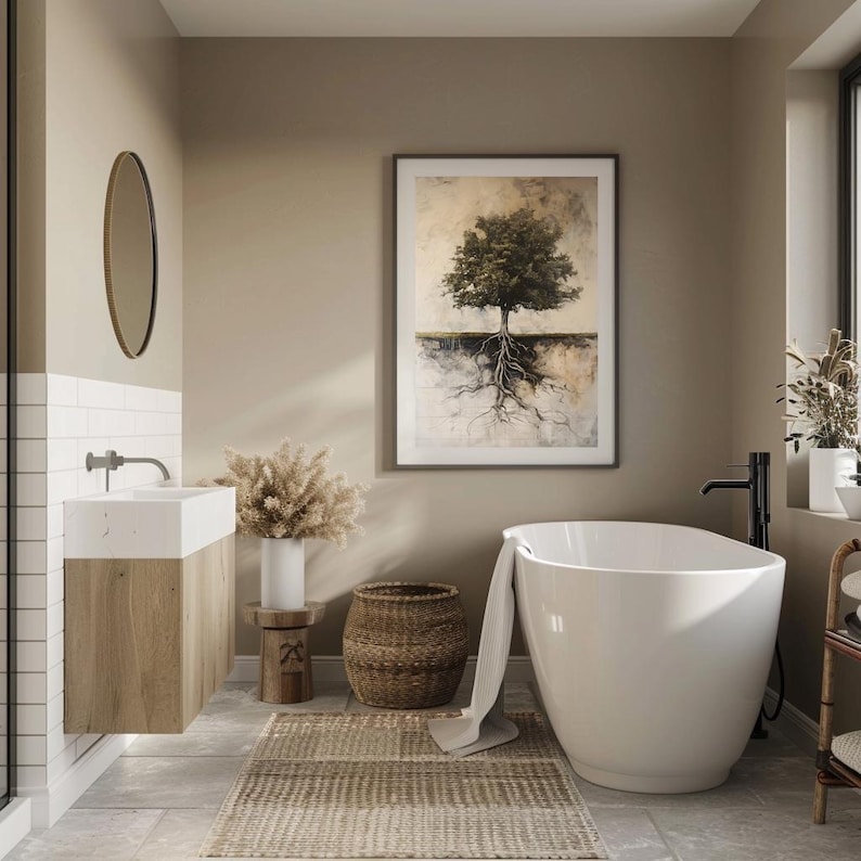 May include: A white bathtub with a brown woven basket and a white towel in a bathroom with beige walls and a framed print of a tree with roots.