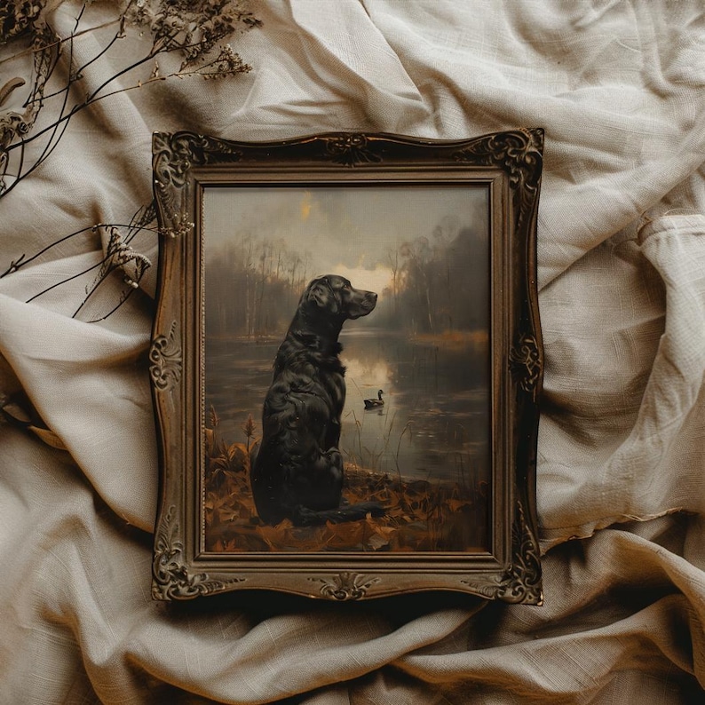 May include: A framed painting depicting a black Labrador Retriever seated by a lake, gazing out at the water. The dog is in the foreground, with the lake in the background. The painting is set in a rustic, woodland scene.