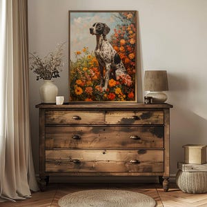 May include: A framed painting of a black and white spotted dog sitting in a field of orange and yellow flowers. The dog is looking to the left of the image.