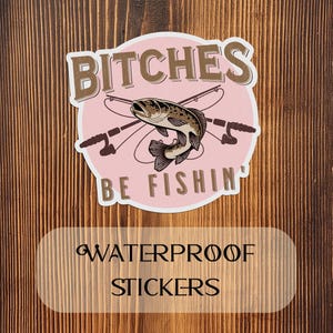 May include: Pink and brown waterproof sticker with a fish and the text "Bitches Be Fishin'"