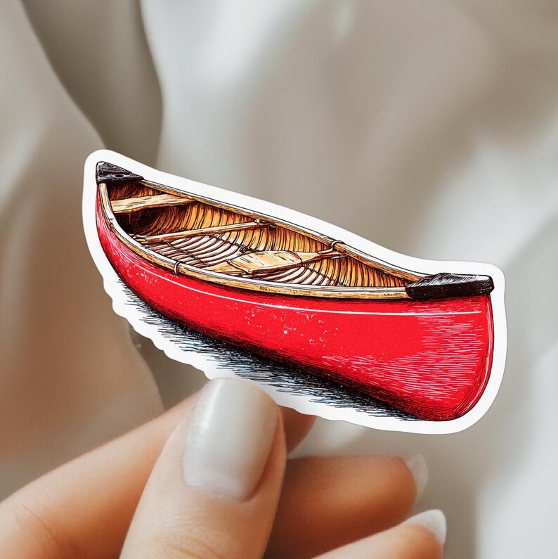 May include: A sticker featuring a detailed illustration of a bright red canoe with a tan wooden interior. The canoe has black end caps and visible cross-ribbing along the hull, rendered with fine black ink lines to show texture and depth.