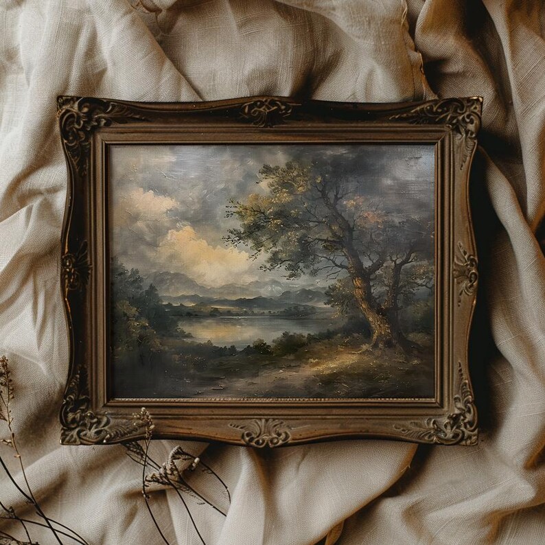 May include: A framed oil painting depicting a landscape scene with a lake, trees, and mountains. The painting is in a dark brown frame with ornate details.
