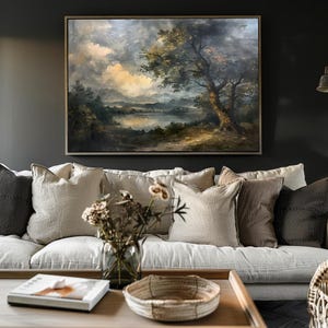 May include: A framed oil painting depicting a landscape scene with a lake, trees, and a cloudy sky. The painting is in a rustic style and features muted colours.