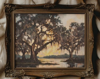 May include: An antique framed landscape painting depicts a serene waterscape with large trees draped in Spanish moss. The artwork features a warm color palette of browns, greens, and yellows, set within an ornate, dark-toned wooden frame.
