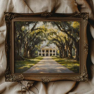 May include: A framed oil painting depicting a white plantation house with a long driveway lined with oak trees. The trees have Spanish moss hanging from their branches. The house has a white facade with columns and a large front porch.