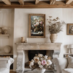 May include: A vintage painting of a bouquet of pink and white roses in a vase, framed in a wooden frame, hanging on a white wall above a stone fireplace.