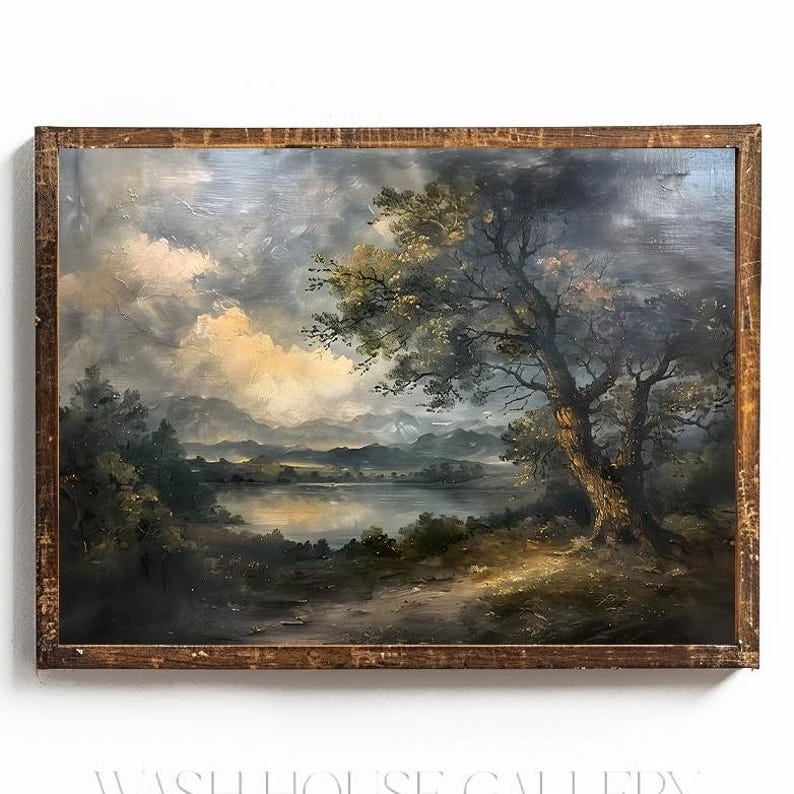 May include: A framed oil painting depicting a landscape scene with a large tree in the foreground, a lake in the middle ground, and rolling hills in the background. The sky is cloudy and the colours are muted.