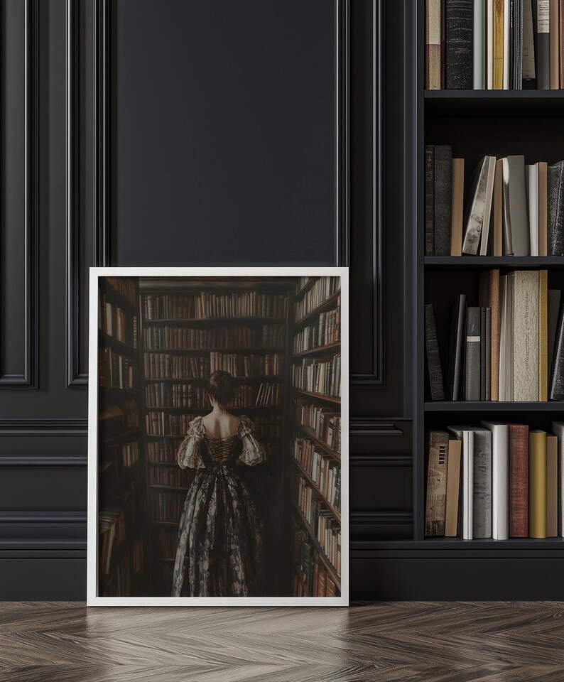 May include: A framed photograph of a woman in a long, dark dress standing in a library with bookshelves lining the walls.