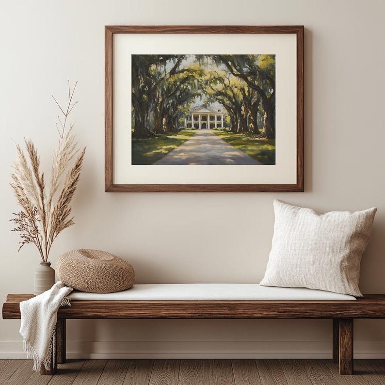 May include: A framed painting of a white building with columns, surrounded by a canopy of green trees. The building is at the end of a long, paved driveway.