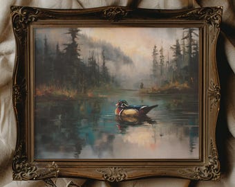 May include: An ornate framed painting depicts a serene lake scene with a colorful duck floating on the water. The artwork features a misty forest backdrop with muted tones of green, blue, and brown, creating a tranquil landscape.