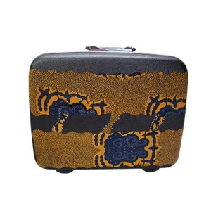 May include: A black and patterned rolling suitcase with a retractable handle. The suitcase features a design with yellow, blue, and black patterns. The suitcase has a rectangular shape and is designed for travel.