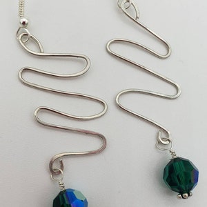 Silver and crystal dangle earrings.