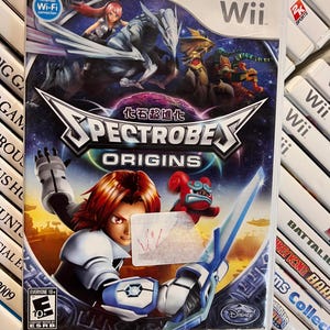 May include: Spectrobes Origins Wii game case. The cover features a dynamic illustration with characters and creatures in a space-themed setting. The game is rated for ages 10+ and includes the Disney logo.