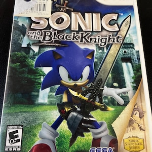 May include: Wii video game case for "Sonic and the Black Knight." The cover features Sonic the Hedgehog in armor, holding a sword. The game's title is prominently displayed, with the Wii logo at the top. The ESRB rating is also visible.