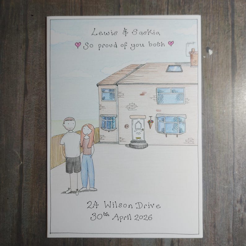 May include: A hand-drawn illustration of a house with a couple standing in front. The text reads "Lewis & Saskia, So proud of you both" with a heart symbol. The address "24 Wilson Drive" and the date "30th April 2026" are also included.