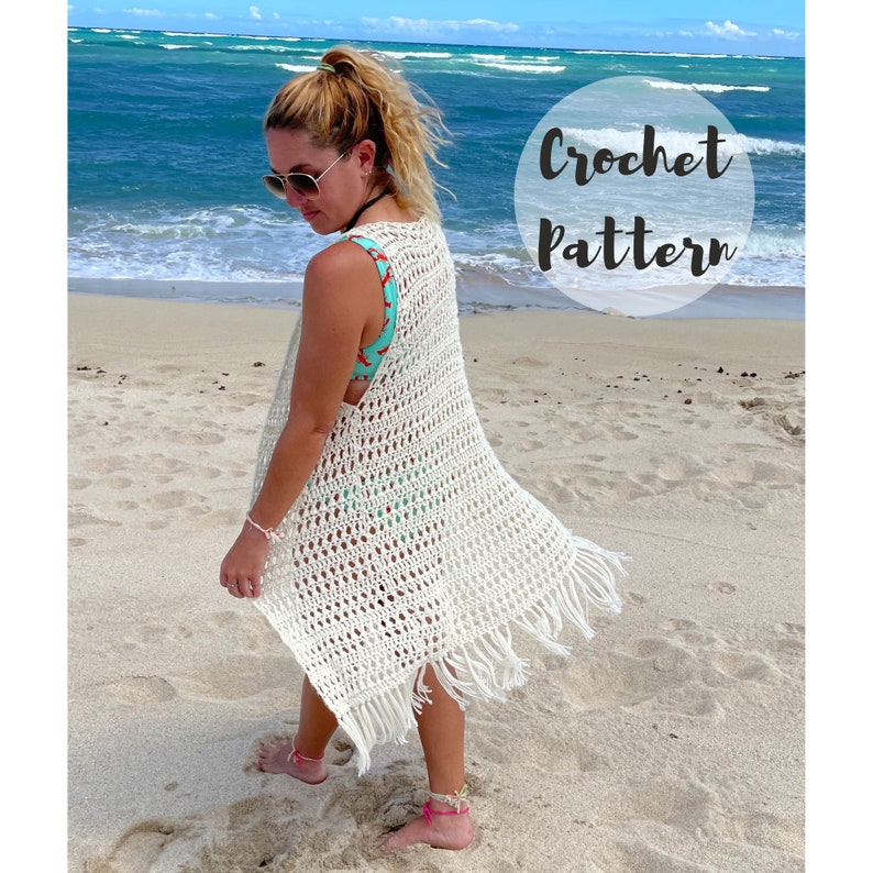 May include: A white crochet beach cover-up with fringe trim. The cover-up is sleeveless and has a loose fit. The text "Crochet Pattern" is visible in the image.