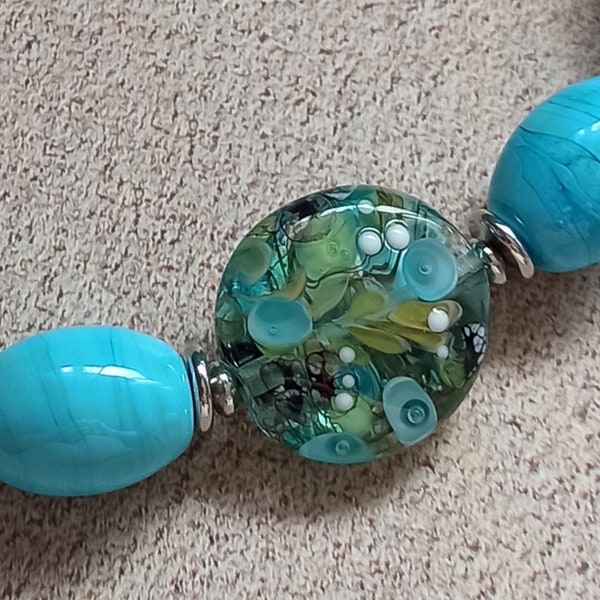 Collier ras de cou, perles de verre au chalumeau, décors fonds marins vert et turquoise transparent .Atelier Il était une flamme.