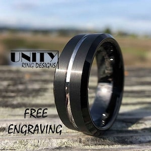 May include: Black tungsten carbide ring with a silver band. The ring is bevelled and has a brushed finish. Free engraving is offered.