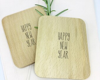 Raclette boards · Happy New Year · Table decoration for raclette, raclette for guests, coaster for raclette pans labeled