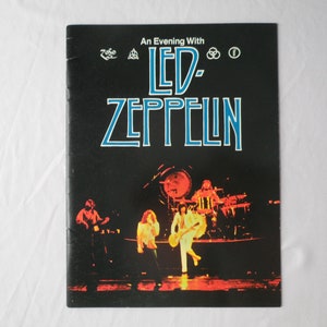 May include: A black and white concert program with the text "An Evening With Led Zeppelin" and a photo of the band performing on stage.