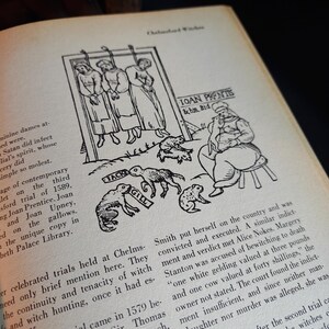 May include: An open book with a black and white illustration depicting a historical scene. The image shows three figures hanging from a gallows, with a man seated nearby and several animal figures. Text includes names and historical details.