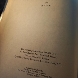 May include: Open book page with text. The text reads "for H. A. M. R." and details about the edition published for BOOKPLAN, Paul Hamlyn Ltd., and Crown Publishers Inc. The book was printed in England by Fletcher & Son Ltd. in 1959.