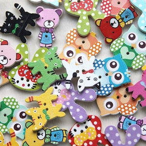 May include: Assortment of colourful wooden buttons featuring various animal and cartoon characters. The buttons are decorated with polka dots and other patterns.