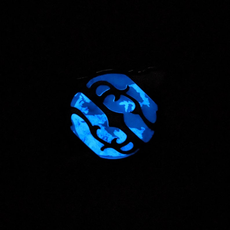 May include: A blue glow-in-the-dark sticker with a swirling, abstract design.