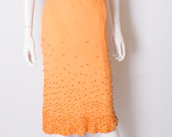 A Vintage 1970s Beaded Orange Skirt