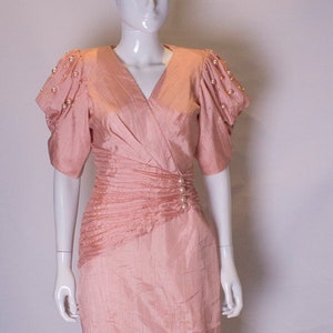 A vintage 1980s Cocktail Dress in Powder Pink with Pearl Decoration