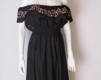 A vintage 1970s embroidered floral black cotton summer festival dress