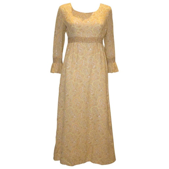 A Vintage 1970s pale yellow Paisley Print Gown Wit
