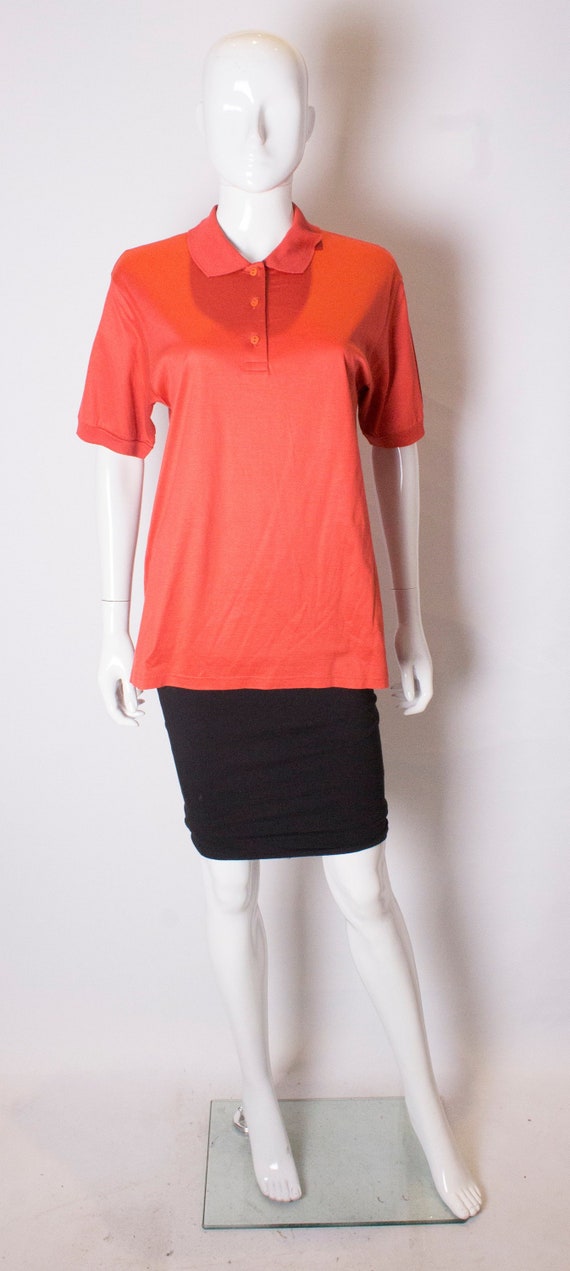 A Vintage 1990s orange Celine Polo Shirt