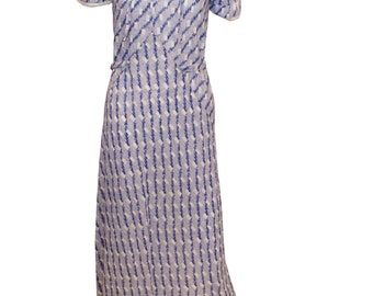 May include: A vintage-style dress featuring a blue and white patterned design. The dress has short sleeves, a large collar with white trim, and a fitted bodice that flows into a long skirt. The fabric has a textured appearance.