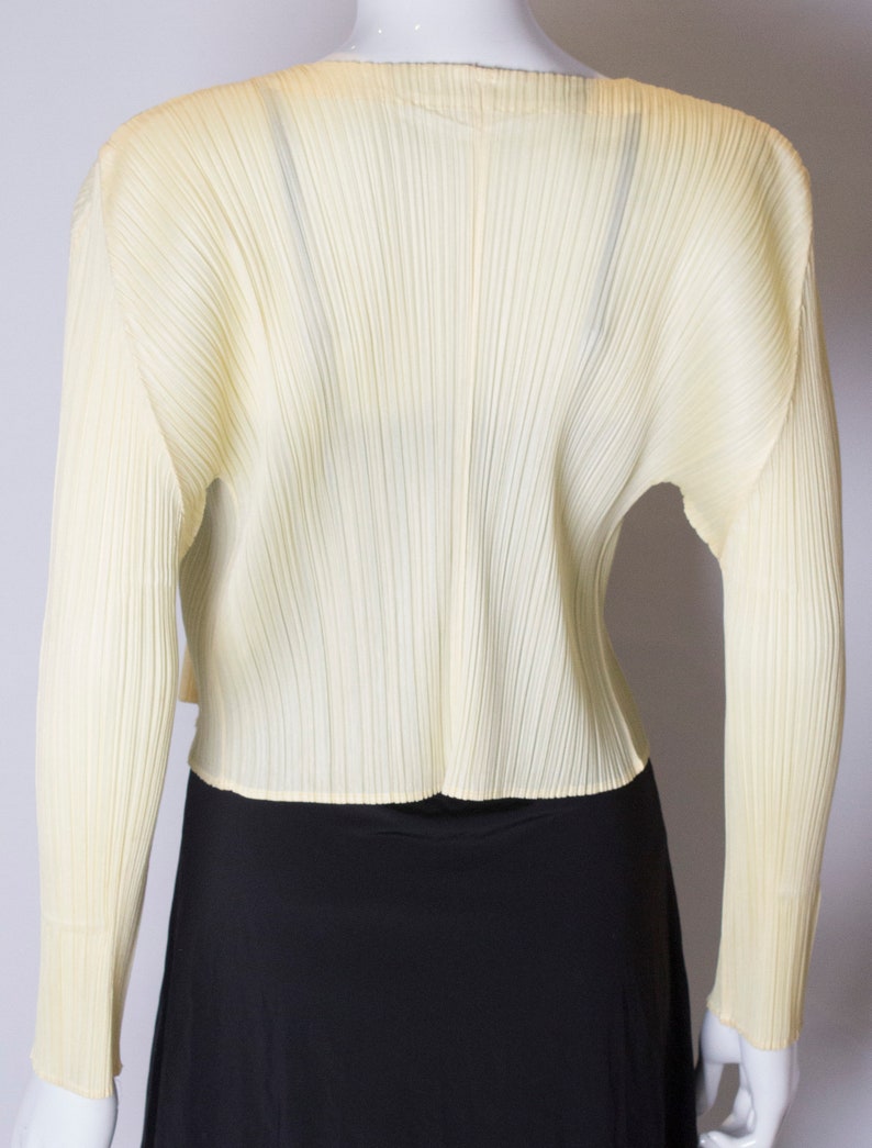 A vintage 1990s Miyake Pleats Please Yellow Cardigan Jacket