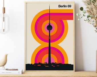 May include: A retro-style poster with a black silhouette of the Berlin TV Tower against a background of concentric orange, pink, and red circles. The text "Berlin 69" is at the top of the poster.