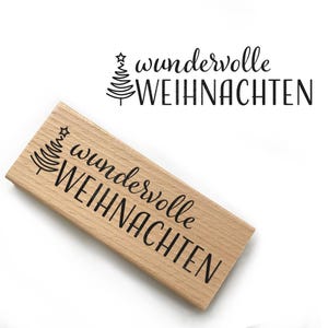 Könnte beinhalten: Ein Holzstempel mit dem Text "wundervolle WEIHNACHTEN" und einem stilisierten Weihnachtsbaumdesign.