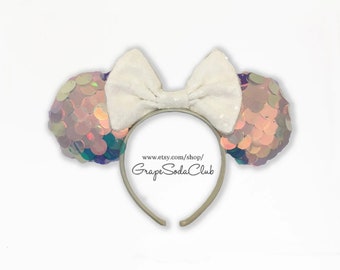 May include: White headband with iridescent pink and purple sequin ears and a white bow. The headband has the text "www.etsy.com/shop/GrapeSodaClub" printed on it.