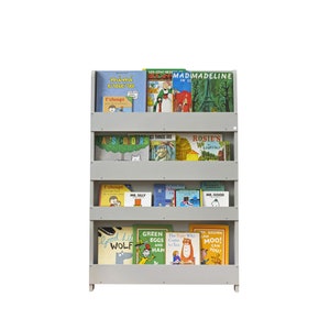 May include: A gray wooden bookshelf with four shelves filled with children's books. The books have colorful covers with various illustrations and titles such as "Green Eggs and Ham", "The Very Hungry Caterpillar", "Madeline", and "Mr. Silly".