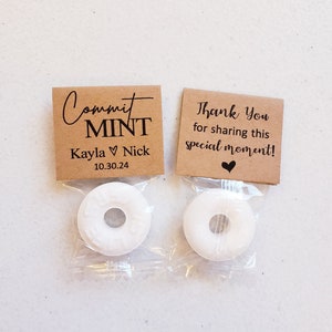 May include: Two small brown paper bags with white mints inside. The bag on the left has the text "Commit Mint Kayla ♥ Nick 10.30.24" printed on it. The bag on the right has the text "Thank You for sharing this special moment!" printed on it.