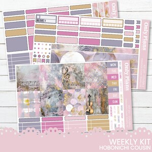 May include: A weekly planner sticker kit designed for the Hobonichi Cousin planner. The kit features a pink, purple, and gold colour scheme with musical notes, a violin, and a moon. The kit includes stickers for daily tasks, appointments, and self-care.