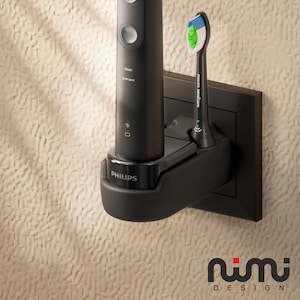 May include: Black Philips Sonicare electric toothbrush and charging base. The toothbrush has a sleek design with the brand name on the base. The brush head has blue, green, and white bristles. The charging base is mounted on a wall.