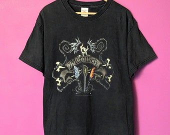 May include: Black t-shirt with a graphic of a skull and crossbones with guitars and the word "Metallica" in a gothic font.